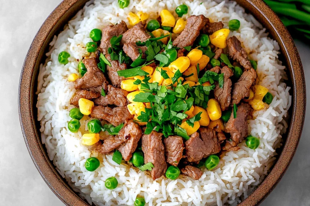 Plated Beef Pepper Rice garnished with green onions and sesame seeds.