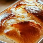 Golden brown loaf of Quick 20-Minute Homemade Bread, sliced to show soft texture, ready to eat.
