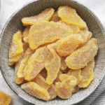 Homemade crystallized ginger in a bowl, ready to enjoy or use in recipes.