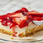 Delicious Strawberry Cheesecake Dump Cake topped with strawberry filling and cream cheese.