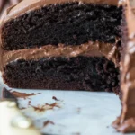 Deliciously rich and moist gluten free chocolate cake topped with creamy frosting