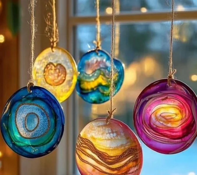 Colorful DIY glue suncatchers hanging in a sunlit window