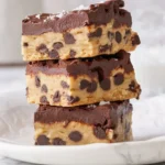 A variety of mini vegan dessert bars presented on a platter, showcasing different flavors.