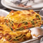 Delicious breakfast lasagna with layers of eggs, bacon, and cheese.