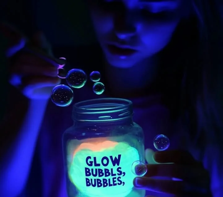 DIY glowing bubbles glowing in dark surroundings, a fun nighttime activity.