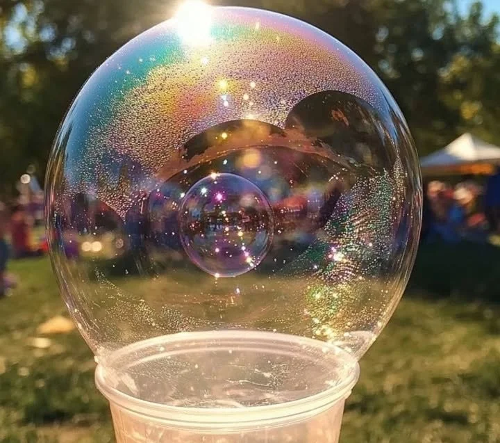 A colorful homemade DIY bubble blower creating bubbles outdoors.