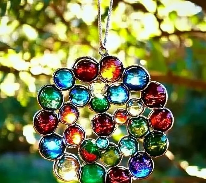 Beautiful Glass Gem Suncatcher catching sunlight in a colorful display