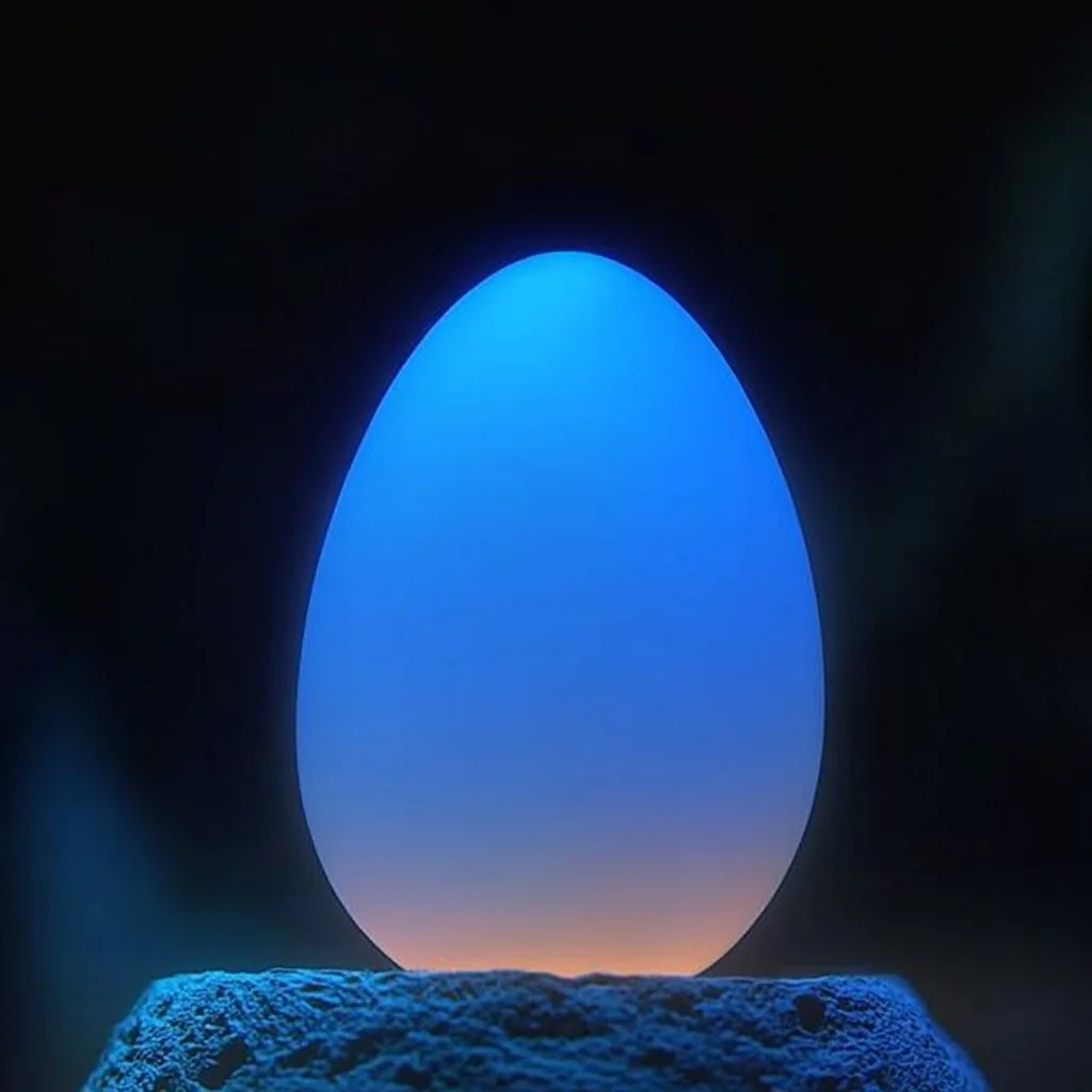 A collection of glowing eggs in various colors illuminating a dark background.