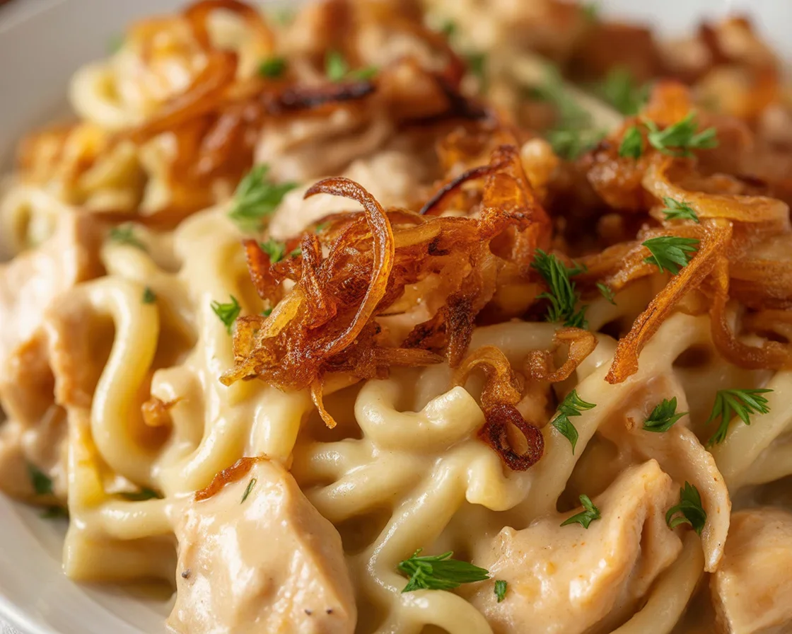 Delicious French Onion Chicken Orzo Casserole topped with melted cheese and caramelized onions.