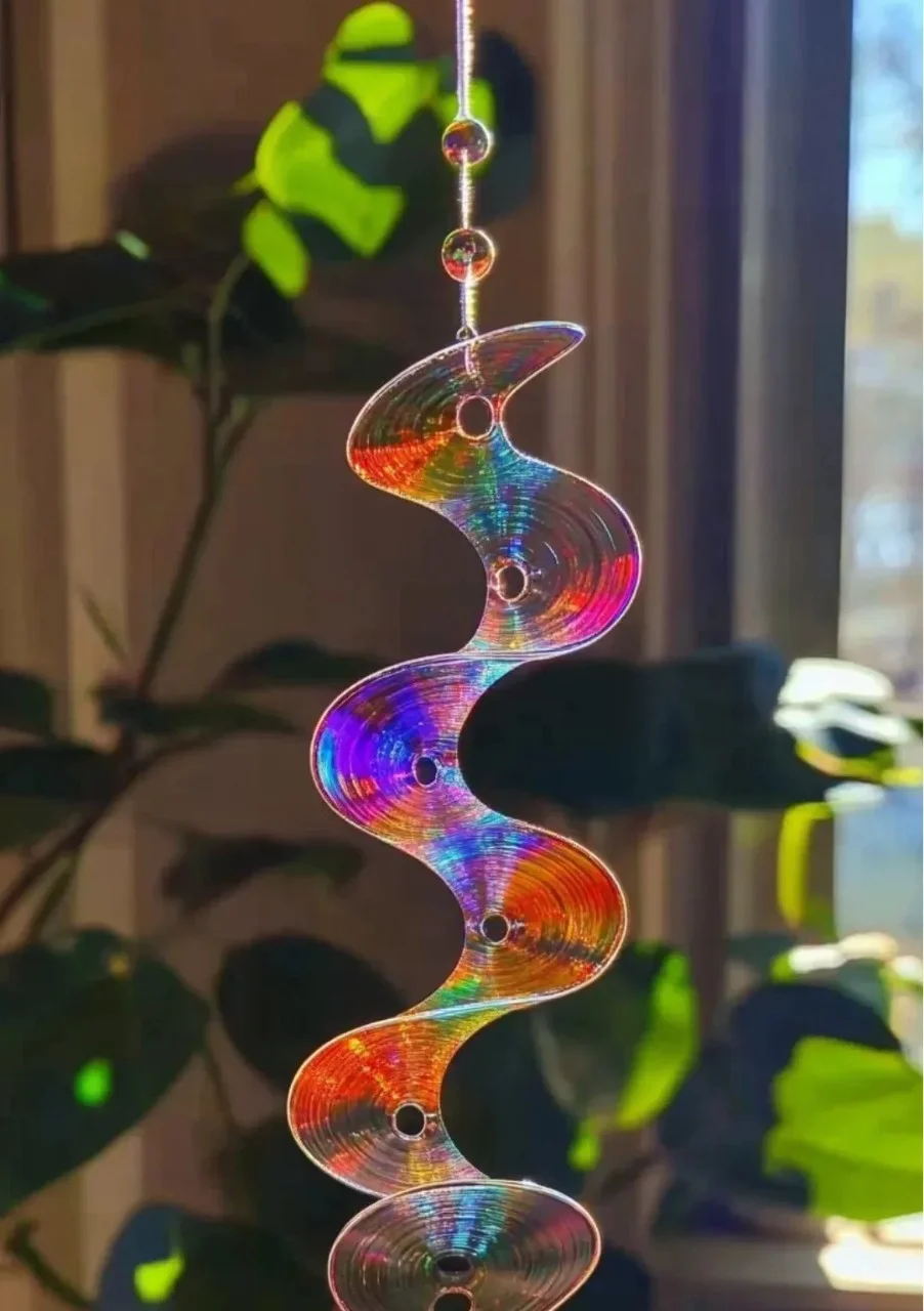 Colorful DIY CD suncatchers hanging in the sun, reflecting vibrant light.