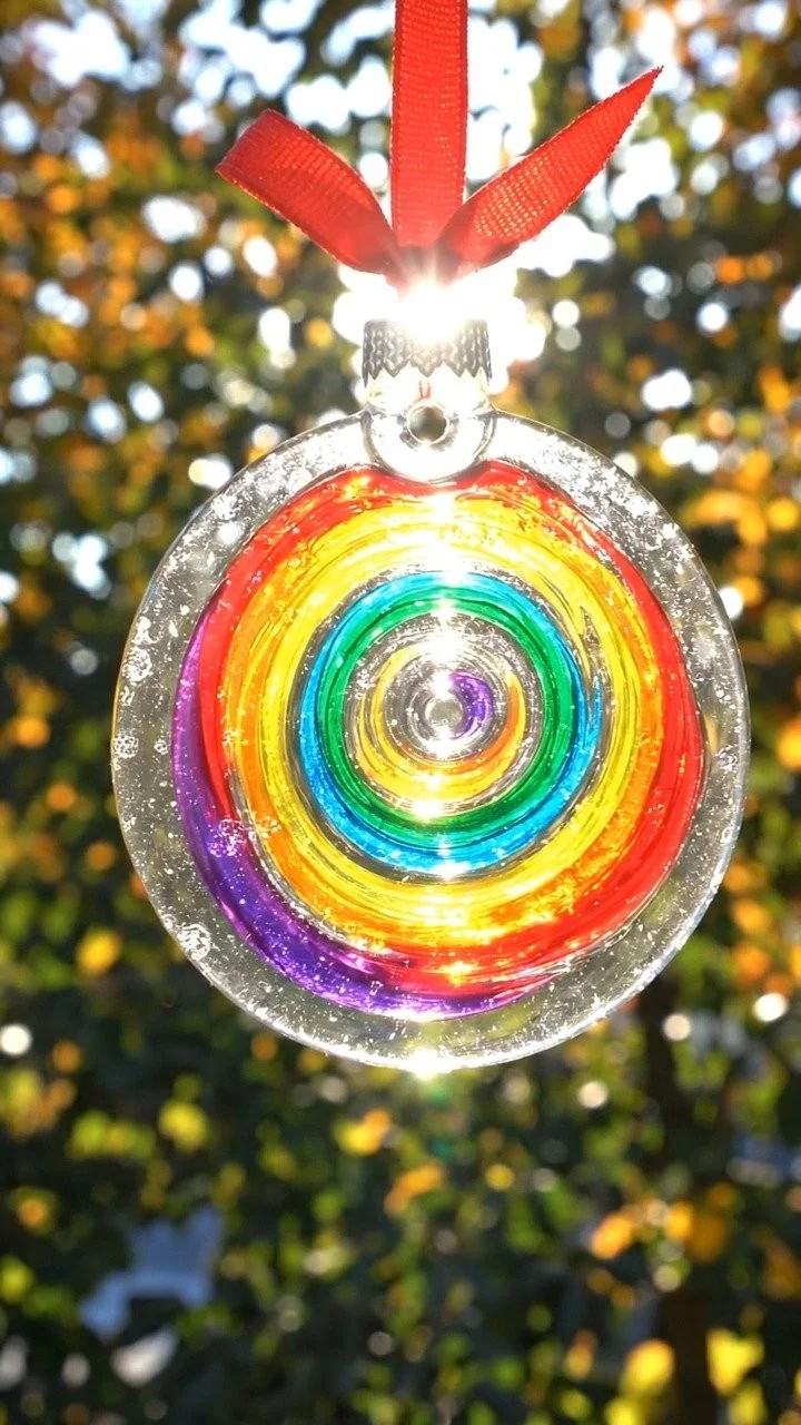 Swirl glue suncatcher ornament sparkles with colorful translucent swirls that catch the light beautifully. 12 Swirl glue suncatcher ornament sparkles with colorful translucent swirls that catch the light beautifully.